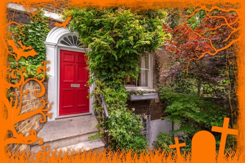 Exterior of a home with brick walls and a bright red door