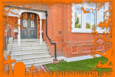 Brick house with colourful glass panels on the front door.