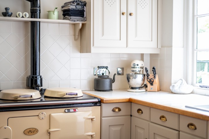 Period cooker and modern cabinets in a bright, airy corner of the kitchen